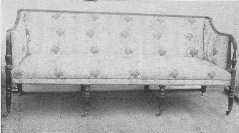 An admirable example of the Sheraton style mahogany
settee with original silk covering.