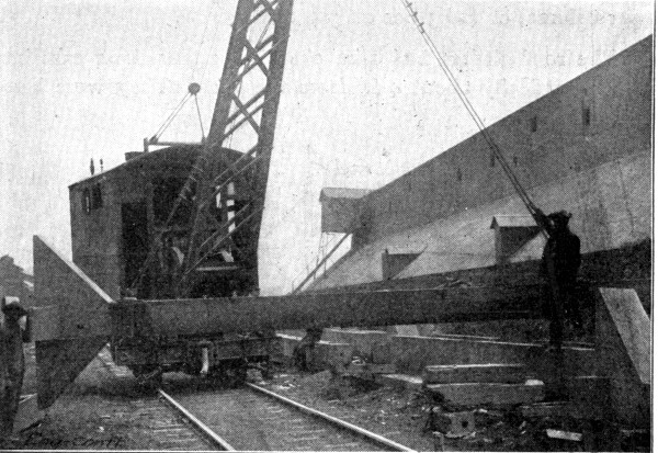 Fig. 243.&mdash;View Showing Method of Hoisting Molded
Columns.