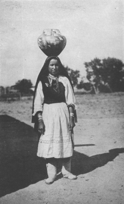 An Indian girl of Isleta, New Mexico, carrying a water
jar.