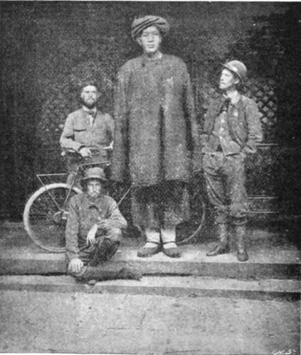 THE THREE WORLD CYCLISTS AND A CHINESE GIANT WHO DOES
NOT CYCLE.