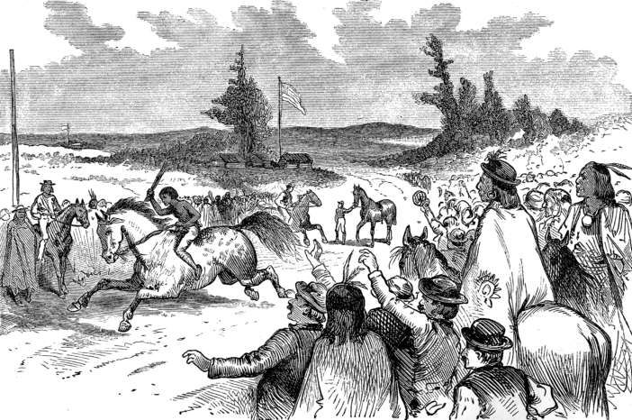 An Indian in the lead amidst a
big spectator crowd.